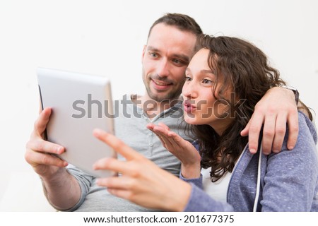 View of a Young happy couple video calling on tablet