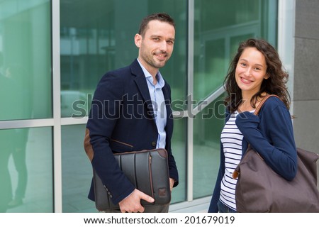 VIew of a business man and woman chatting together after work