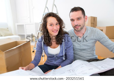 View of a Young couple watching plans in their new flat