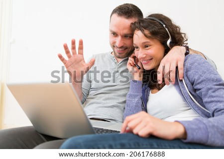 View of a Young happy couple video calling on computer