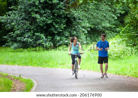 View of a Young sportive couple jogging at the park