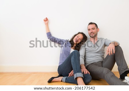 View of a Young couple in their brand new flat / Textspace