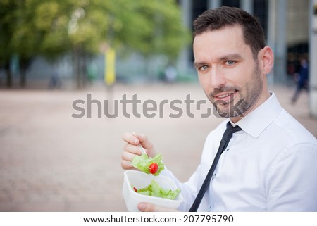 View of a Businessman eating salad for lunch break