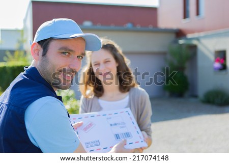 View of a Delivery man handing over a registered mail