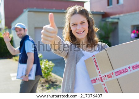 Attractive woman happy after being delivered a parcel