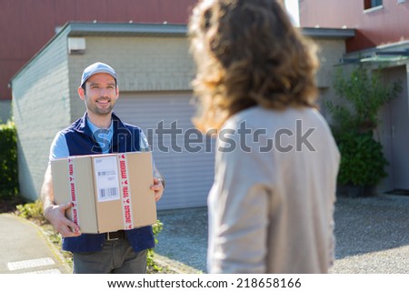 View of a Young attractive delivery man on his way to customer