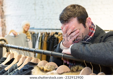 View of a Young casual man waiting while his wife\'s shopping