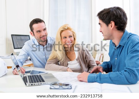 View of a young serious couple meeting a real estate agent