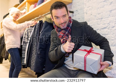 View of a Young attrative man preparing gift surprise