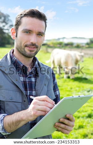 View of a Young attractive farmer working in a field