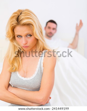 View of a Young attractive couple having an argue in bed