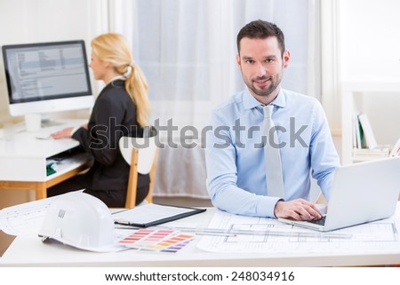 View of a Young attractive engineer working at the office