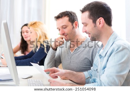View of Young attractive people working together at the office