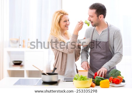 View of a Young attractive woman give food to her husband to taste