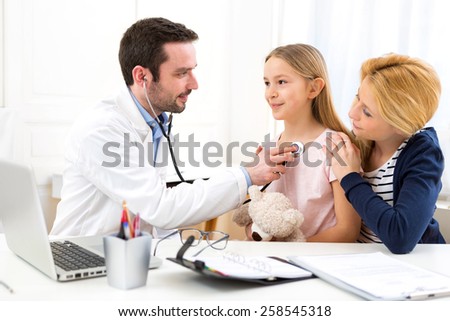 View of a Doctor listening heart beatment of little girl