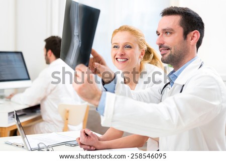 View of a Medical team analysing together a x ray at the hospital