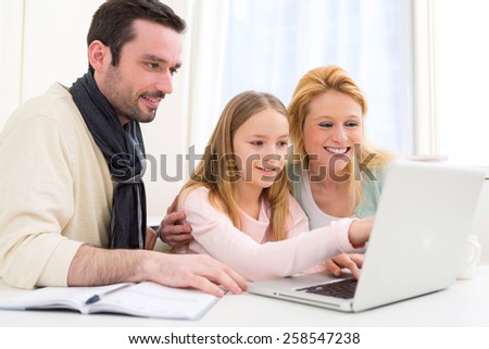 View of a Happy family in front of a laptop
