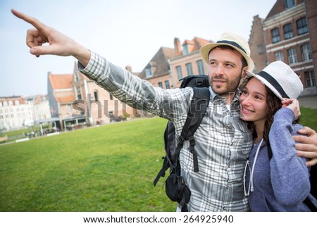 View of a Couple of young attractive tourists discovering city
