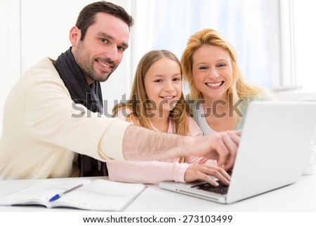 View of a Happy family in front of a laptop