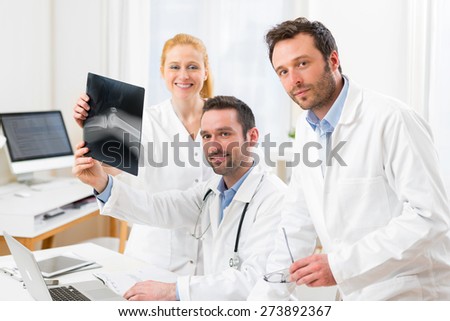 View of a Medical team analysing together a x ray at the hospital