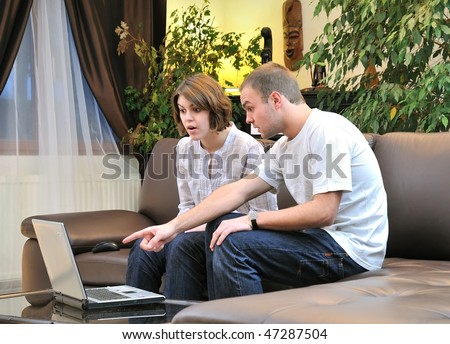 sister and brother in front of computer