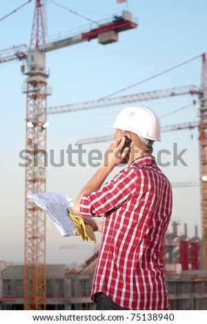 Young architect working on location on a construction site