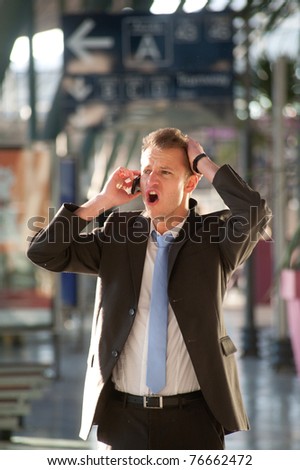 Young business man angry at telephon