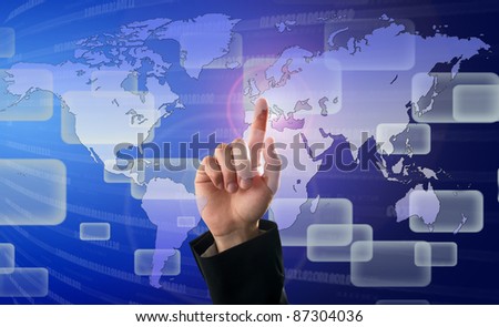 Finger pushing button on a touch screen interface with world map