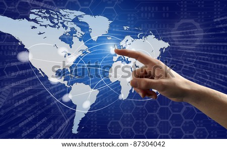 Finger pushing button on a touch screen interface with world map