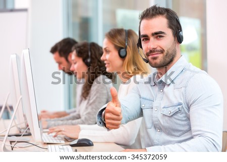 View of a Young attractive man working in a call center