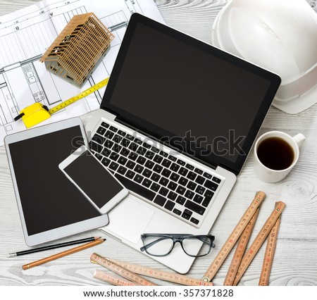 View of a Wood architect\'s desk in high definition with laptop, tablet and mobile