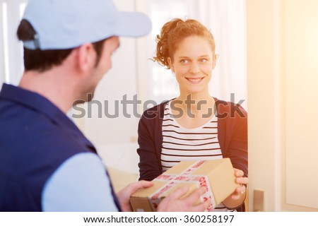 View of a Delivery man handing over a parcel to customer