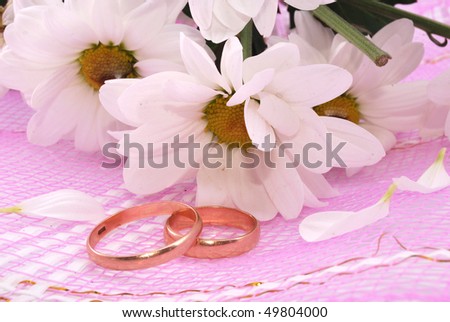stock photo Wedding rings and flowers composition White petals