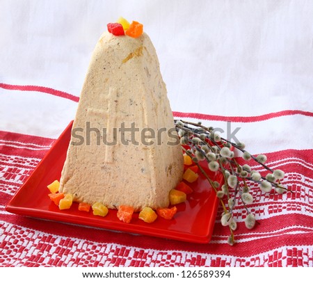 Traditional easter kulich from pressed of raw curd with the candied fruits and bouquet of willow
