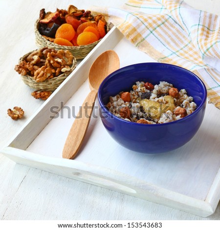 Vegan breakfast of oatmeal with honey and walnuts  on a white tray