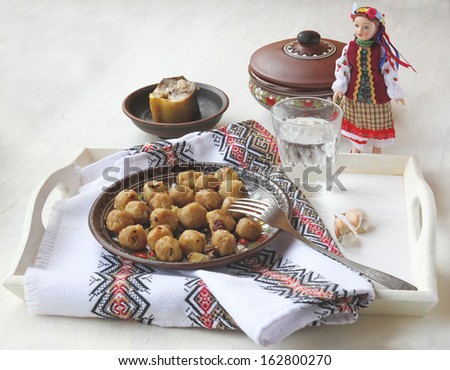 Doll in the national Ukrainian costume and Ukrainian ethnic food \