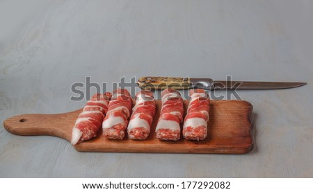 Cooking of lunch on meat rolls and knife