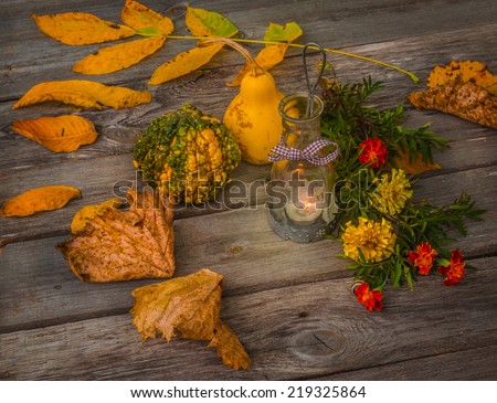 Autumn still life with lamp, pumpkin and leaves