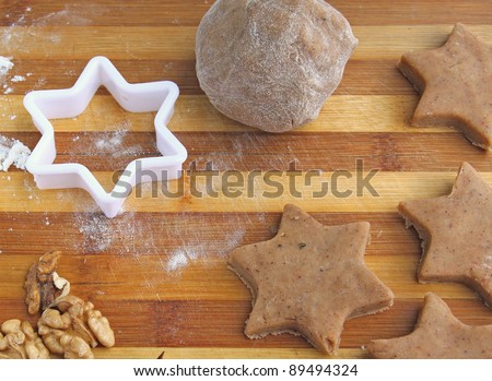 Dough with the sticks of cinnamon on a wooden board. Preparation to Christmas