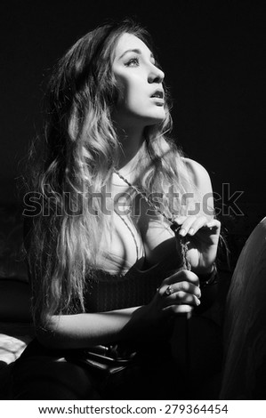 Black and white photo of attractive sensual young woman with long hair, seductive female on luxury photo shoot