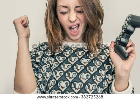 closeup of a girl who rejoices after winning a video game,isolated on White background - lifestyle, technology and people concept