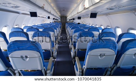 Empty aircraft cabin during flight. Blue salon.