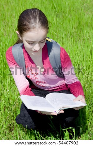 Girl with book. Studying on nature.