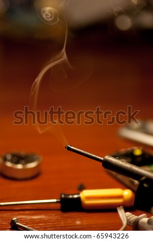Soldering iron and smoke close up