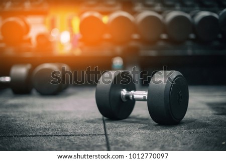 Gym and dumbbell weight training equipment on sport ,Healthy life and gym exercise equipments and sports concept ,copy space