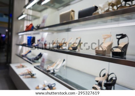 Blur of city shopping people crowd at marketplace shoe shop abstract background.