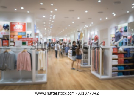 blurred abstract background of multicolored cotton clothing on the shelves of fashion shop.