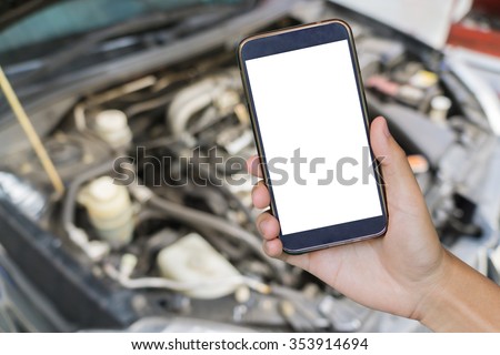 closeup of man with broken car and smart phone, Man hand holding mobile smart phone , tablet,cellphone over Blurred of car technician repairing the car in garage background.