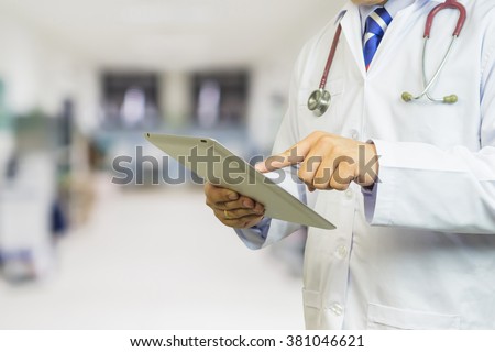 Healthcare And Medicine,doctor using digital tablet computer at work,Doctor pointing on tablet PC,application form while consulting and talking with patient in doctors office,hospital,selective focus