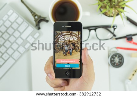 BANGKOK, THAILAND - FEB 20,2016:A man holds Apple iPhone with Airbnb application on the screen.Airbnb is a website for people to list, find,and rent lodging.Airbnb an online platform for accommodation